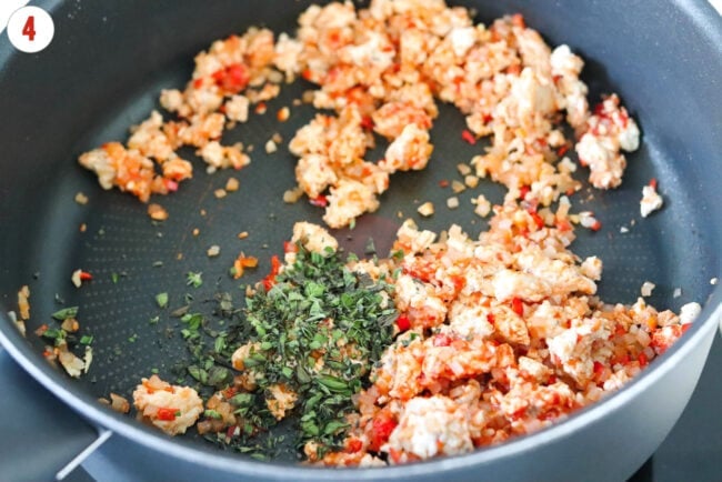 Fresh oregano in pan with sautéed aromatics and ground chicken with tomato paste.